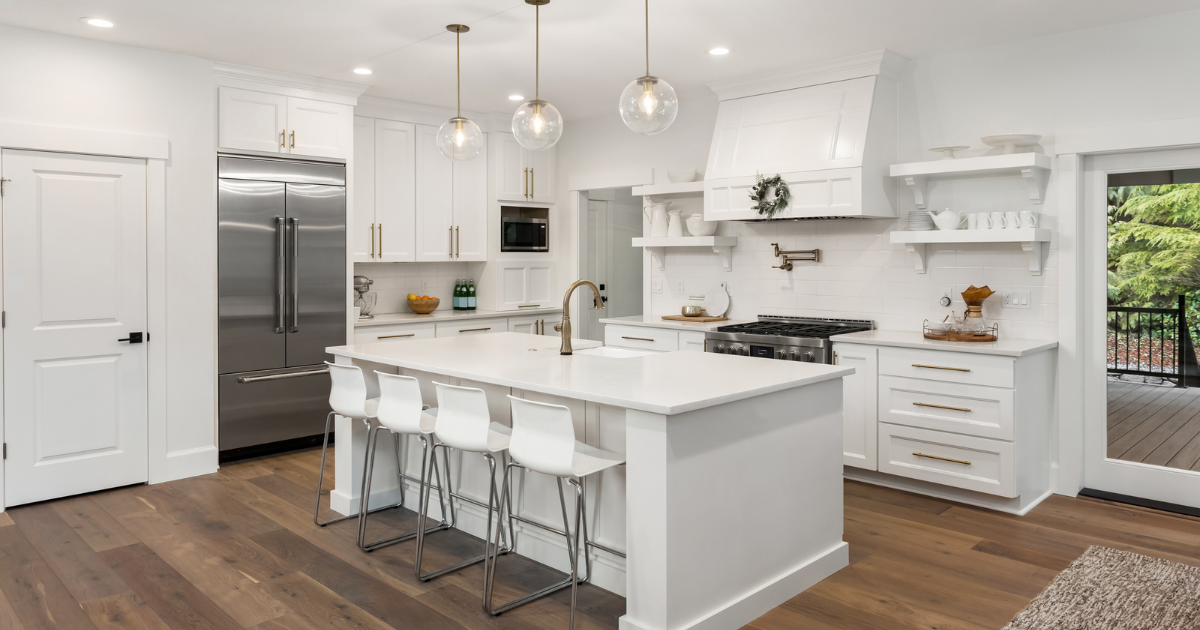 Modern white kitchen with engineered wood flooring in Las Vegas home by One Stop 4 Flooring showcasing durable and stylish design.