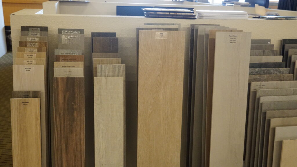 Luxury vinyl plank and wood look flooring samples in a Las Vegas showroom for durable kitchen flooring and waterproof flooring upgrades